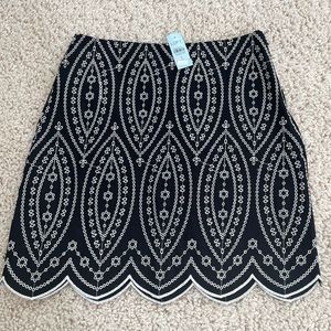 Short skirt from Loft. Black with white embroidery design. Size 4 petite.